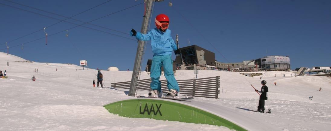 Kind bij het LAAX-bord op de piste